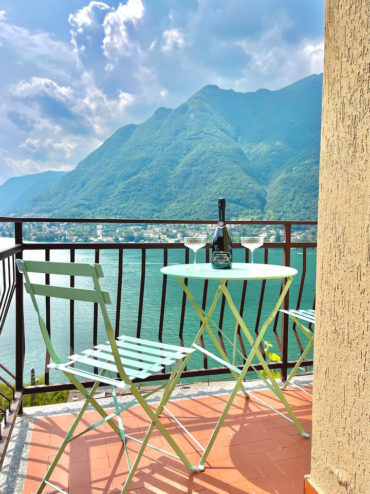 Balcony bistro table with prosecco and the lake